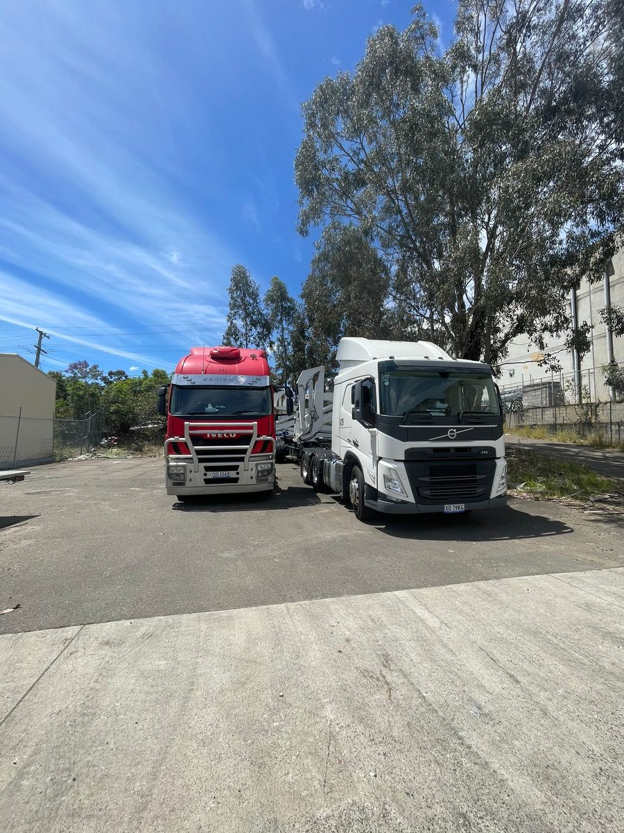 Aardiv prime movers and container trailers parked at a yard in Western Sydney