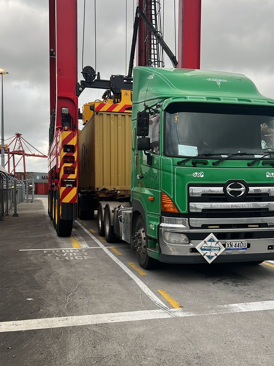 An Aardiv truck under the straddle carriers at a container terminal
